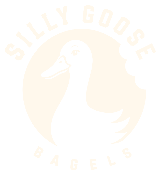Silly Goose Bagels, with a white goose inside a bitten red bagel